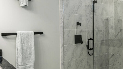 Bathroom with custom shower door and matte black finish hardware
